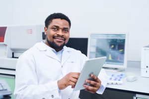 Confident black medical expert in laboratory